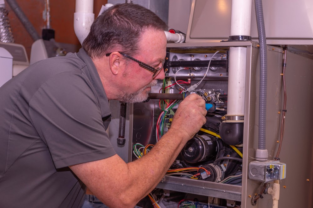 man repairing furnace