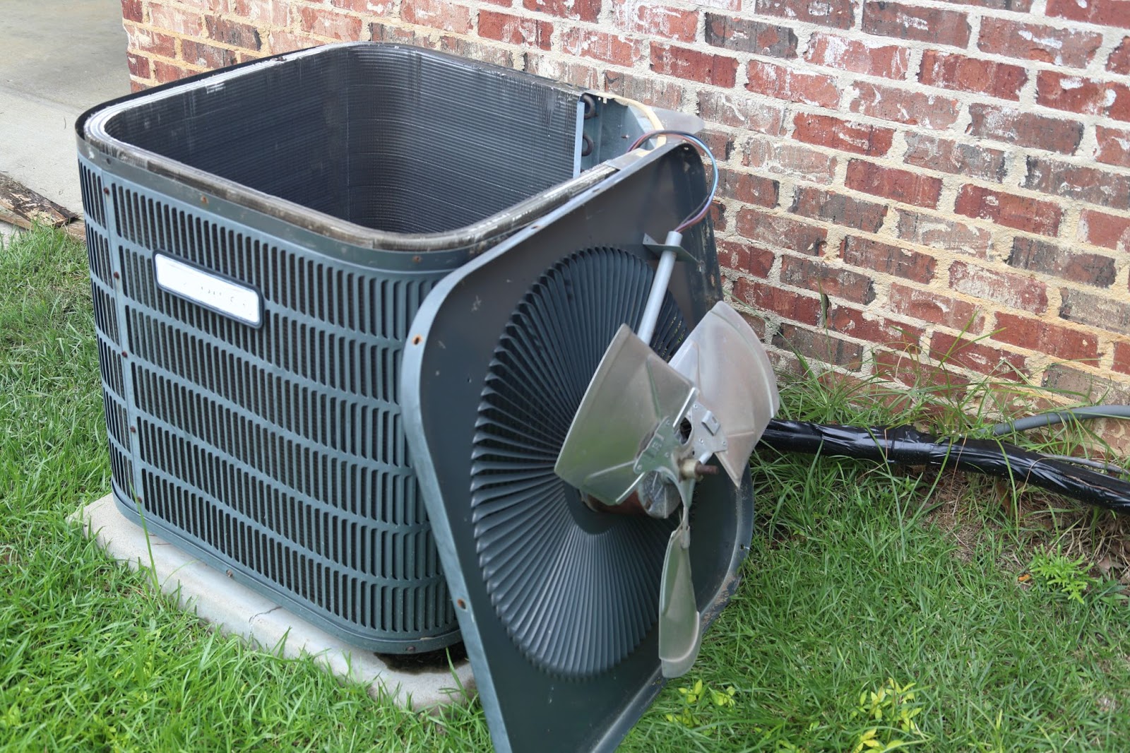 An outdoor HVAC unit with the access panel removed.