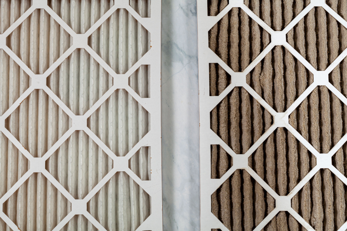 A clean air filter next to a dirty air filter to showcase the differences